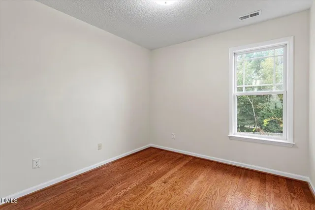 a view of a room with wooden floor and staircase
