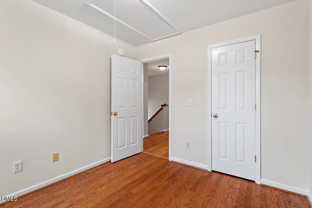 1039 Dual Parks Road Apex, NC 27502 - Photo 25 of 46 a view of a room with wooden floor and staircase