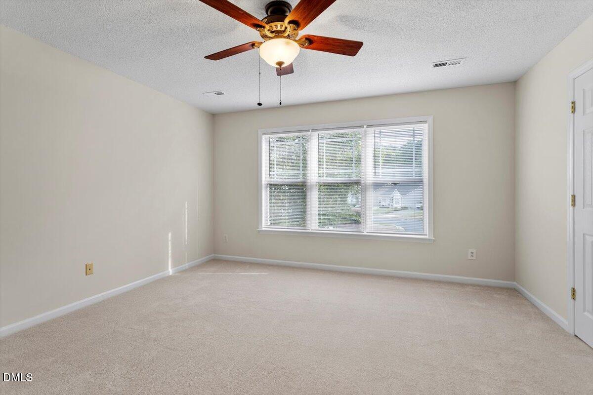 1039 Dual Parks Road Apex, NC 27502 - Photo 28 of 46 an empty room with a window and a fan