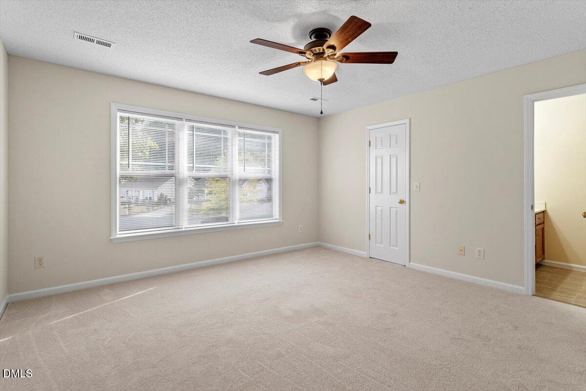 1039 Dual Parks Road Apex, NC 27502 - Photo 29 of 46 an empty room with windows and fan