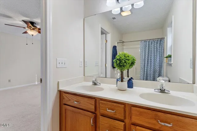 a bathroom with a toilet and a shower curtain