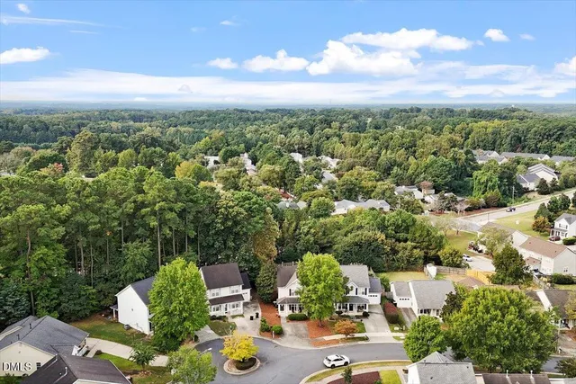 an aerial view of a house with lots of trees