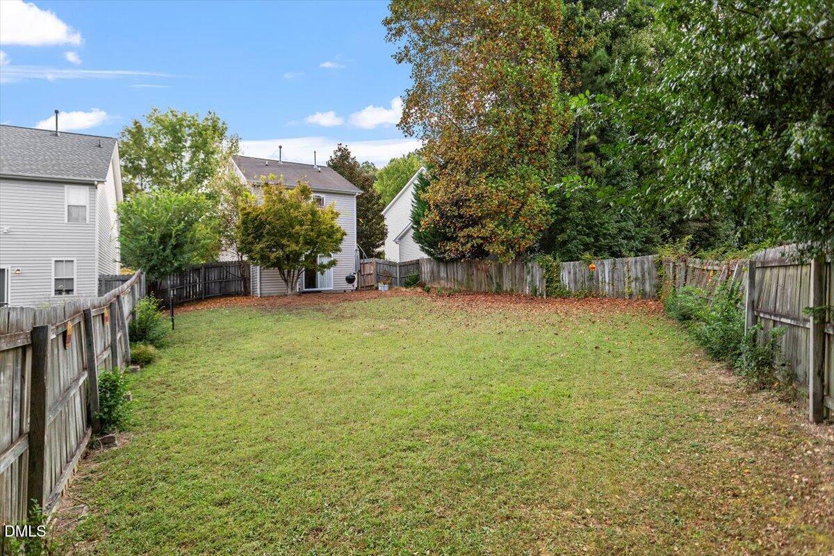 1039 Dual Parks Road Apex, NC 27502 - Photo 6 of 46 a view of a backyard with a tree