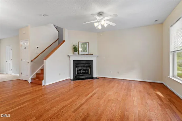 a view of empty room with window and fireplace