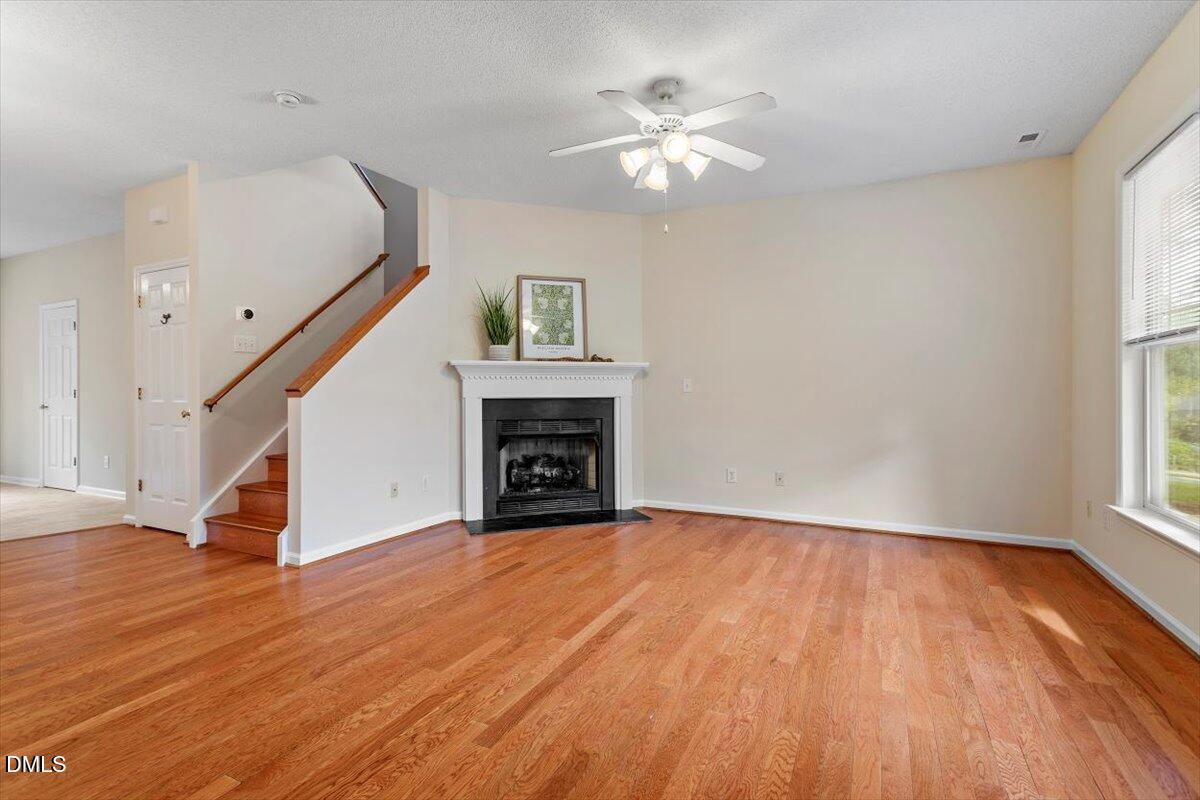 1039 Dual Parks Road Apex, NC 27502 - Photo 8 of 46 a view of empty room with wooden floor and fan