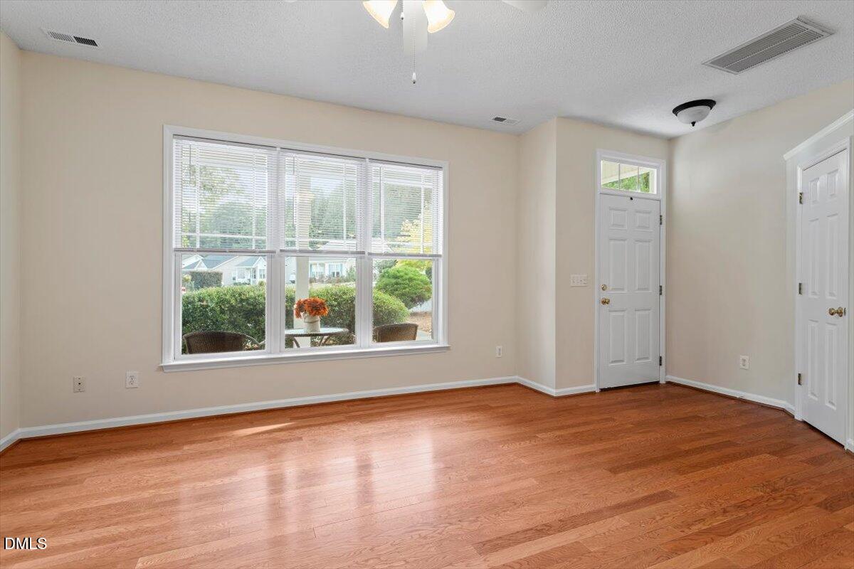 1039 Dual Parks Road Apex, NC 27502 - Photo 10 of 46 an empty room with wooden floor and windows