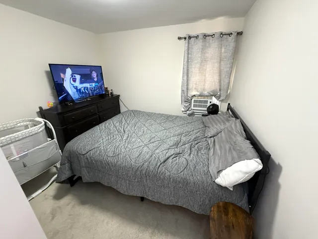 a bedroom with a bed and a view of bathroom