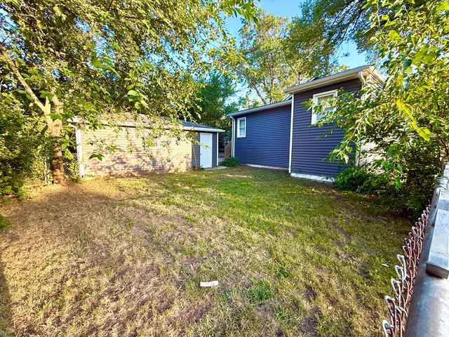 a view of backyard with large trees