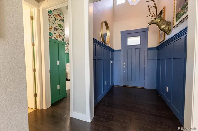 a view of a hallway with wooden floor and stairs