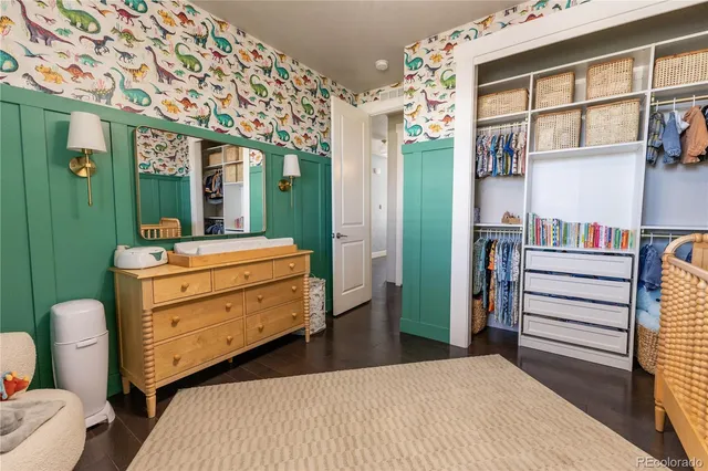 a room with a bed and a dresser