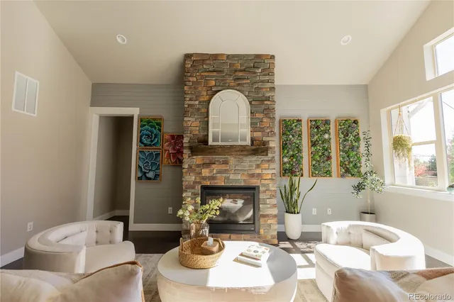 a living room with furniture and a fireplace