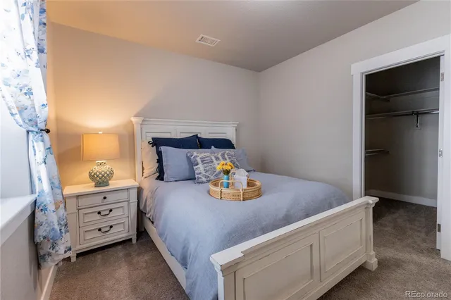 a bedroom with a bed and dresser