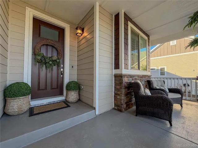 a living room with furniture and potted plants