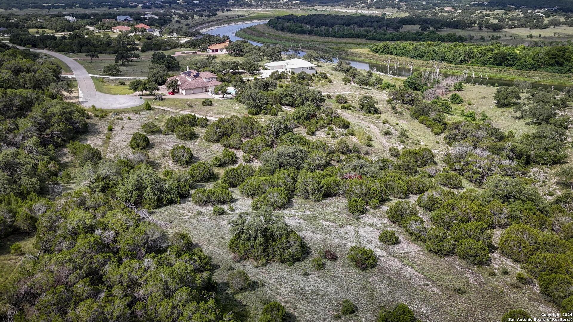 228 Enigma Avenue Spring Branch, TX 78070 - Photo 21 of 39 a view of a lake with a building