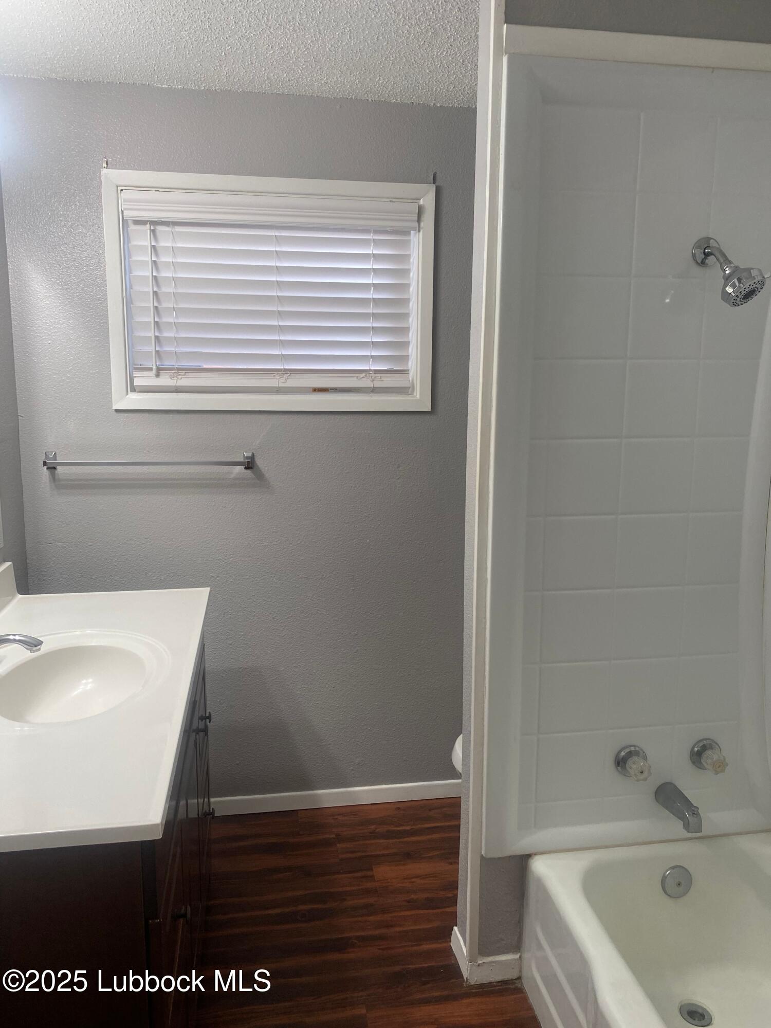 2704 68th Street Lubbock, TX 79413 - Photo 9 of 12 a bathroom with a sink and a bathtub