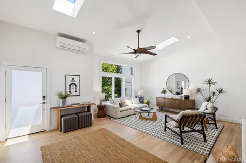 a living room with furniture kitchen view and a fireplace
