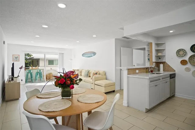 a living room with furniture and kitchen view
