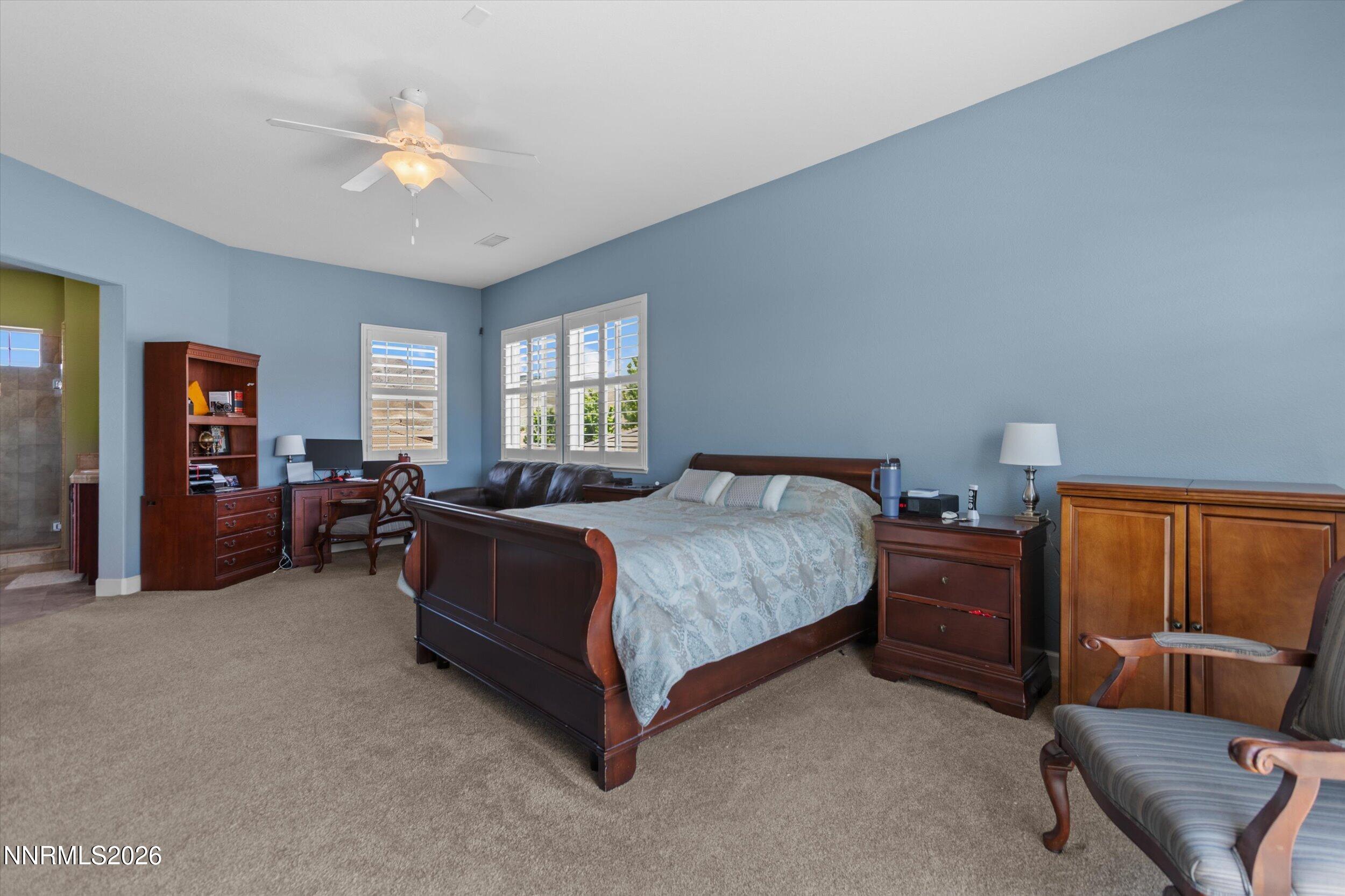 2920 Bull Rider Drive Reno, NV 89521 - Photo 32 of 51 a spacious bedroom with a bed and furniture