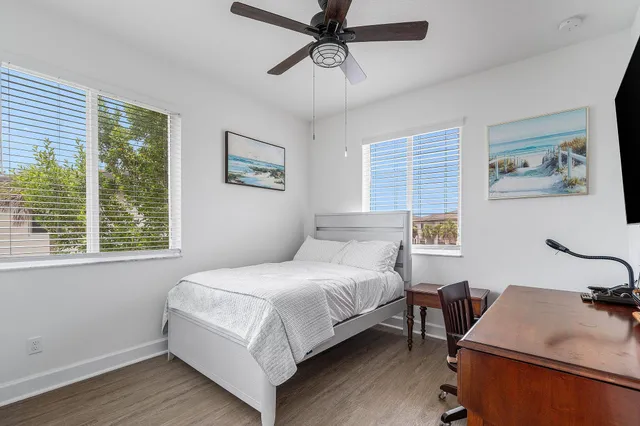 a bedroom with a bed window and a table