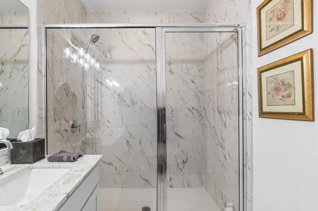 a bathroom with a granite countertop shower and a sink