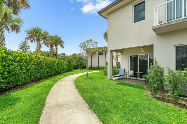 a view of a house with backyard sitting area and garden