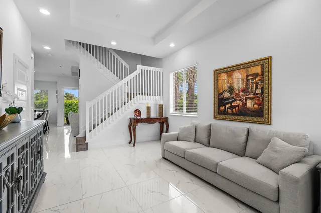a living room with furniture and stairs