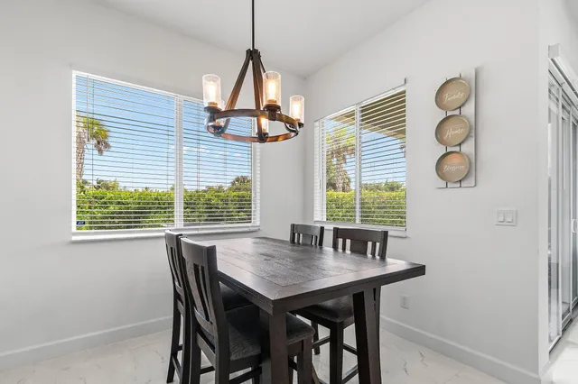 a view of a dining room with a table and chairs
