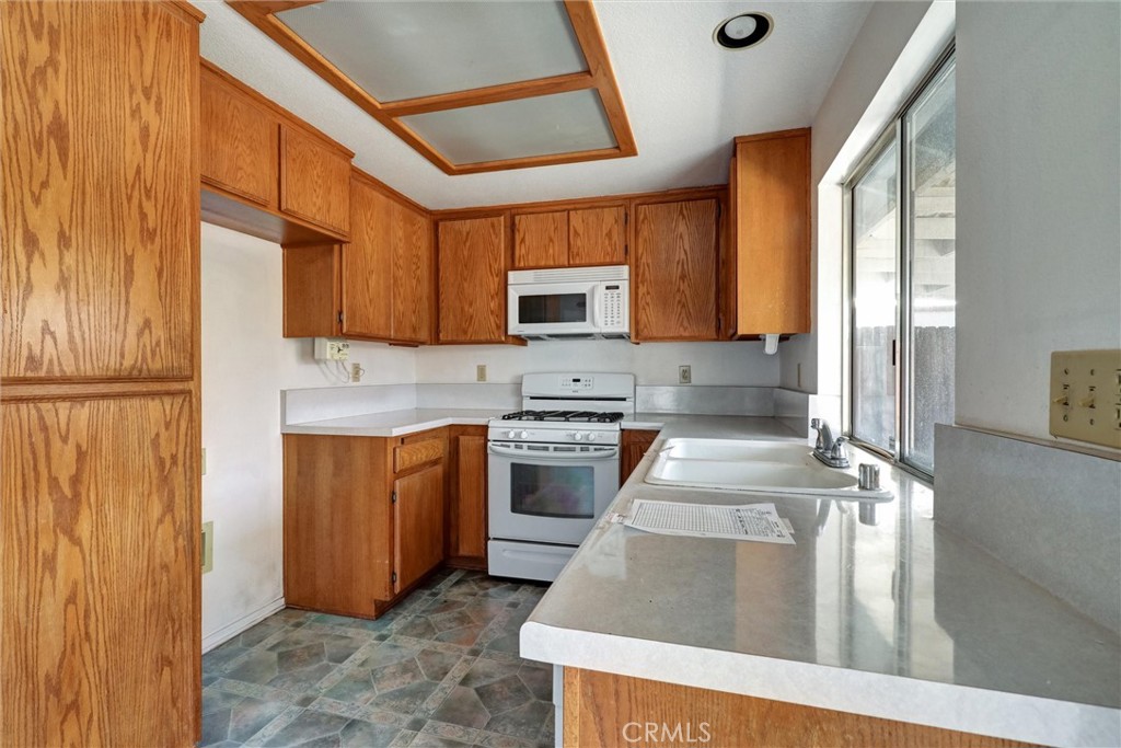 769 Don Drive Hemet, CA 92543 - Photo 13 of 27 a kitchen with stainless steel appliances granite countertop a stove a sink and a microwave