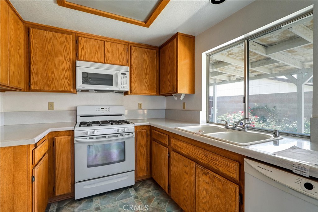 769 Don Drive Hemet, CA 92543 - Photo 14 of 27 a kitchen with a sink stove top oven and microwave