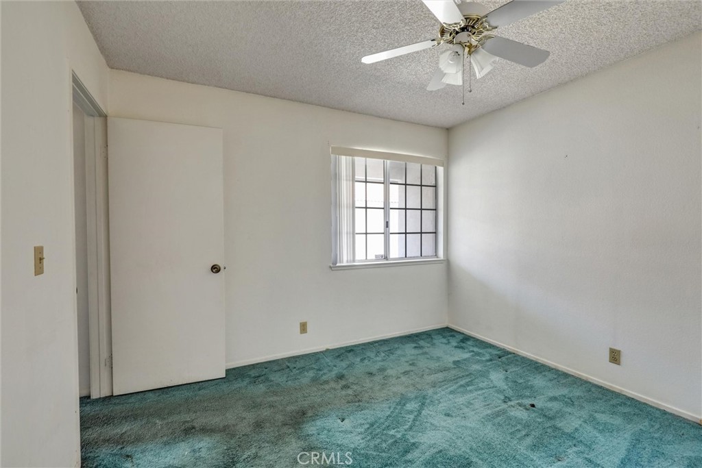 769 Don Drive Hemet, CA 92543 - Photo 16 of 27 an empty room with chandelier fan and windows