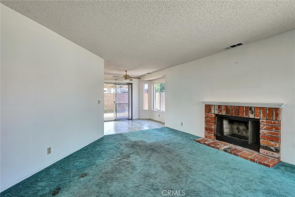 769 Don Drive Hemet, CA 92543 - Photo 7 of 27 a view of empty room with a fireplace