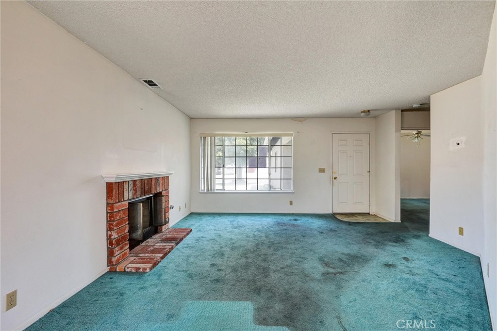 769 Don Drive Hemet, CA 92543 - Photo 10 of 27 a view of an empty room with a window and a kitchen
