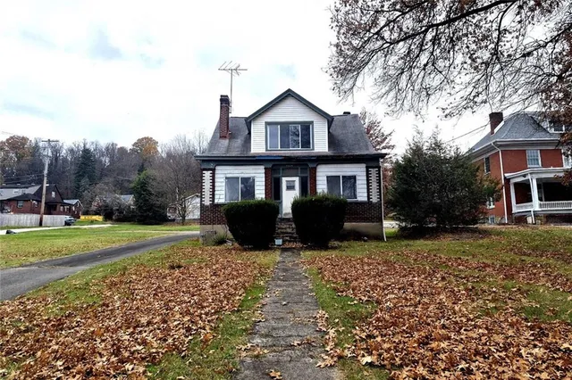 a view of a house with a yard and sitting area