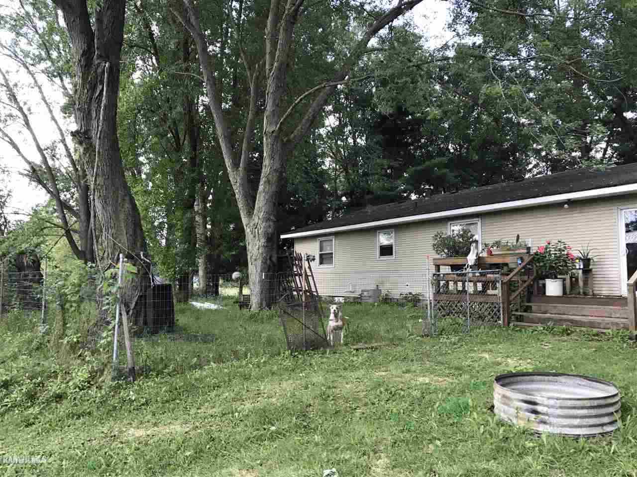 18069 Scenic Ridge Road Savanna, IL 61074 - Photo 3 of 22 a backyard of a house with barbeque oven and outdoor seating
