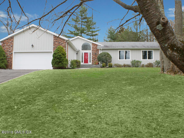 57 Long Meadow Road Riverside, CT 06878 - Photo 1 of 18 a front view of a house with garden