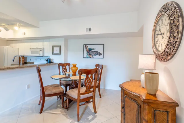 a dining room with furniture and a mirror