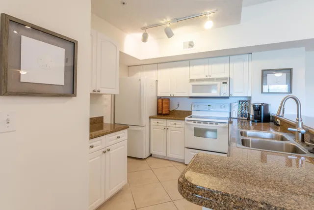 a kitchen with a stove a sink and a refrigerator