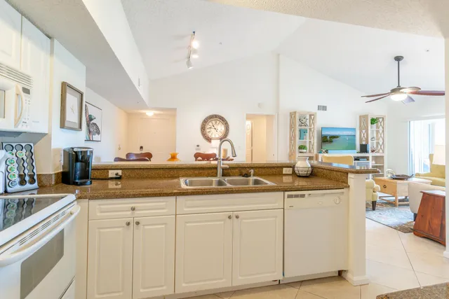 a kitchen with white cabinets and sink