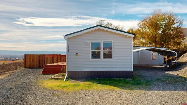 a backyard of a house with barbeque oven