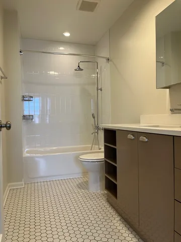 a bathroom with a toilet a sink and a shower