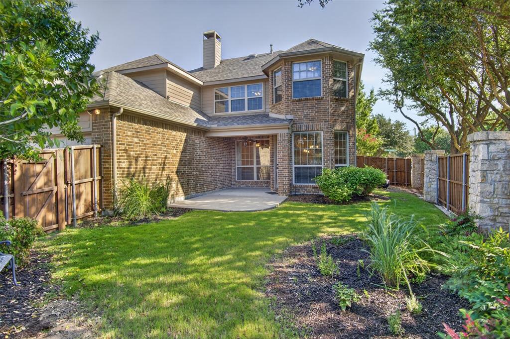 842 Sun Meadow Road Allen, TX 75013 - Photo 3 of 39 Expansive backyard featuring a manicured lawn, established landscaping, and a brick exterior with multiple windows