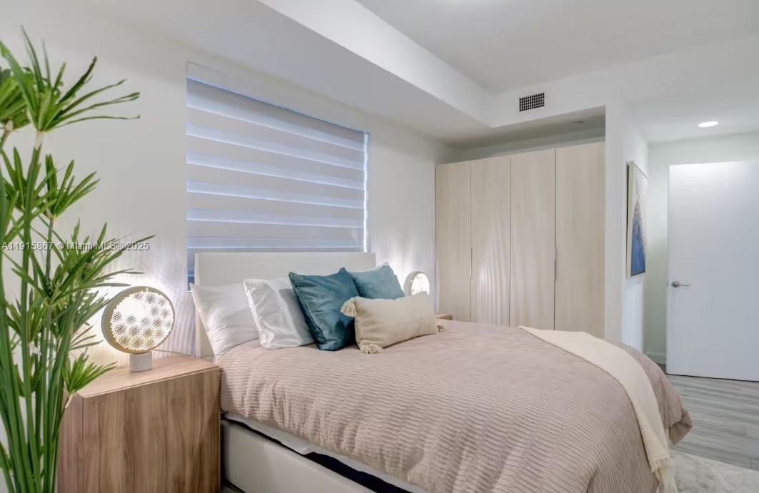 2955 Bird Avenue, Unit PHA Miami, FL 33133 - Photo 15 of 24 a bedroom with bed and a potted plant