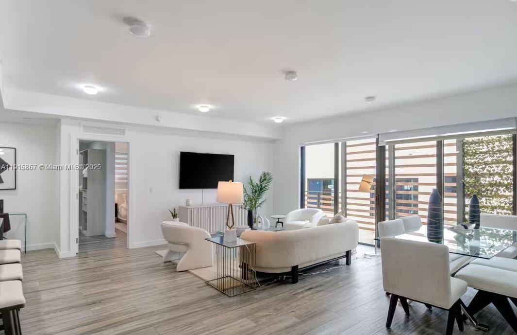 2955 Bird Avenue, Unit PHA Miami, FL 33133 - Photo 2 of 24 a living room with furniture and a flat screen tv