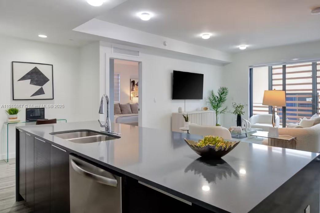 2955 Bird Avenue, Unit PHA Miami, FL 33133 - Photo 6 of 24 a living room with furniture and a flat screen tv