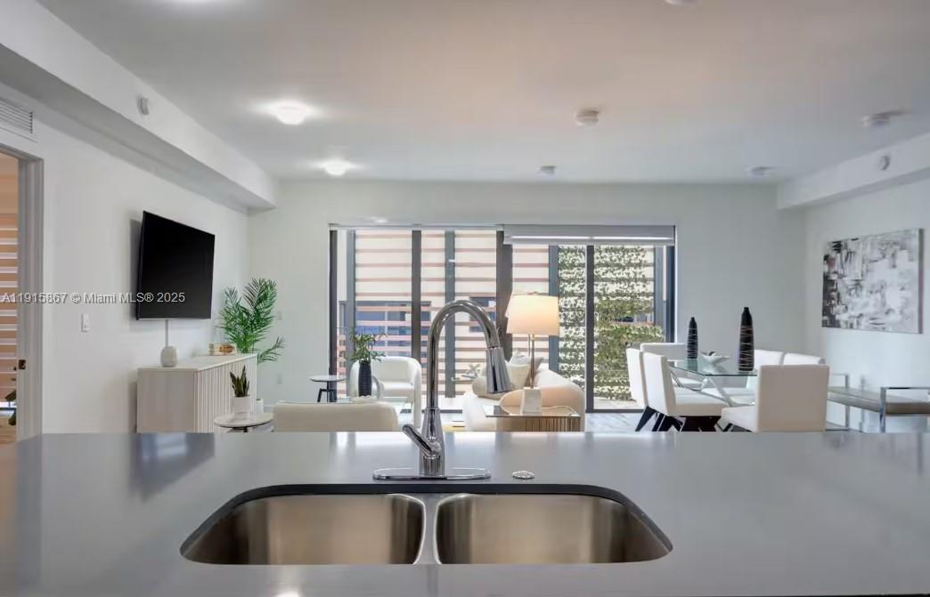 2955 Bird Avenue, Unit PHA Miami, FL 33133 - Photo 8 of 24 a kitchen with a sink and a large window