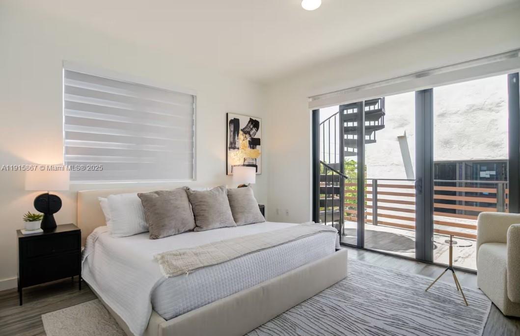 2955 Bird Avenue, Unit PHA Miami, FL 33133 - Photo 9 of 24 a bedroom with a bed and a large window