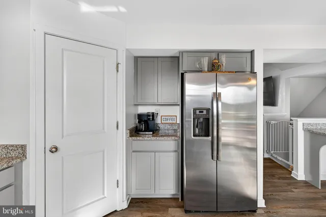 a metallic refrigerator freezer sitting in a kitchen