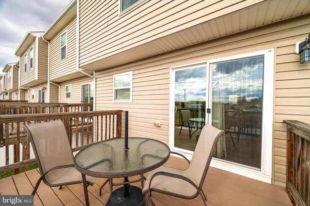 a outdoor dining space with furniture and wooden floor