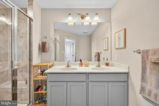 a bathroom with a double vanity sink and a mirror
