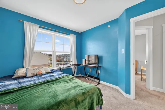 a bedroom with a bed and large windows